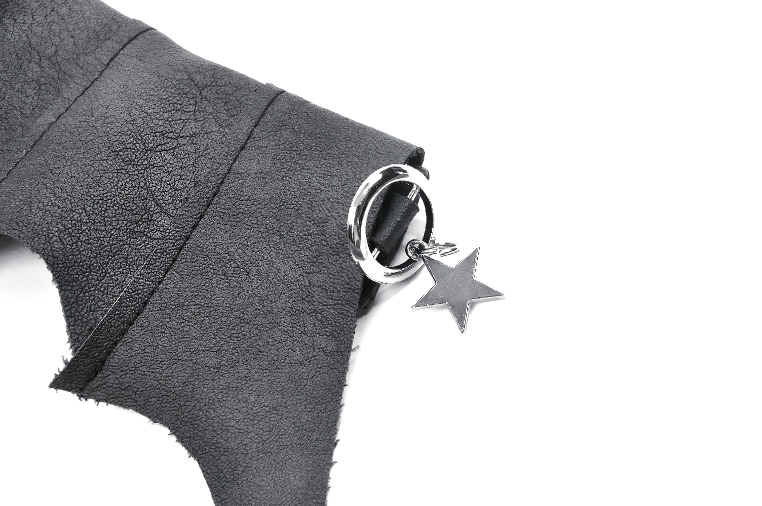 Close-up of a bat wing faux leather choker collar with star charm and O-ring detail, showcasing gothic fashion vibes.