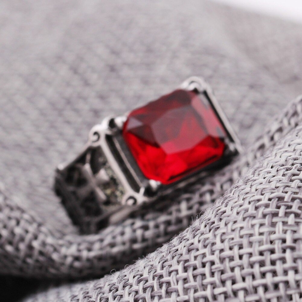Biker 316L stainless steel ring featuring a big red CZ zircon set against textured gray fabric.