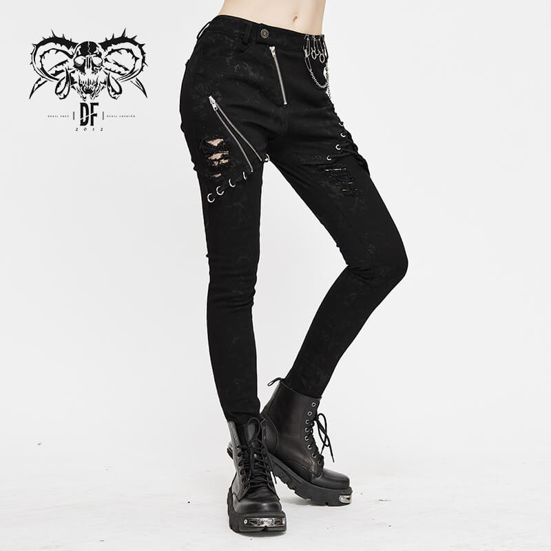 Stylish biker women's punk skinny jeans, black ripped trousers with lace-up details and silver chains.