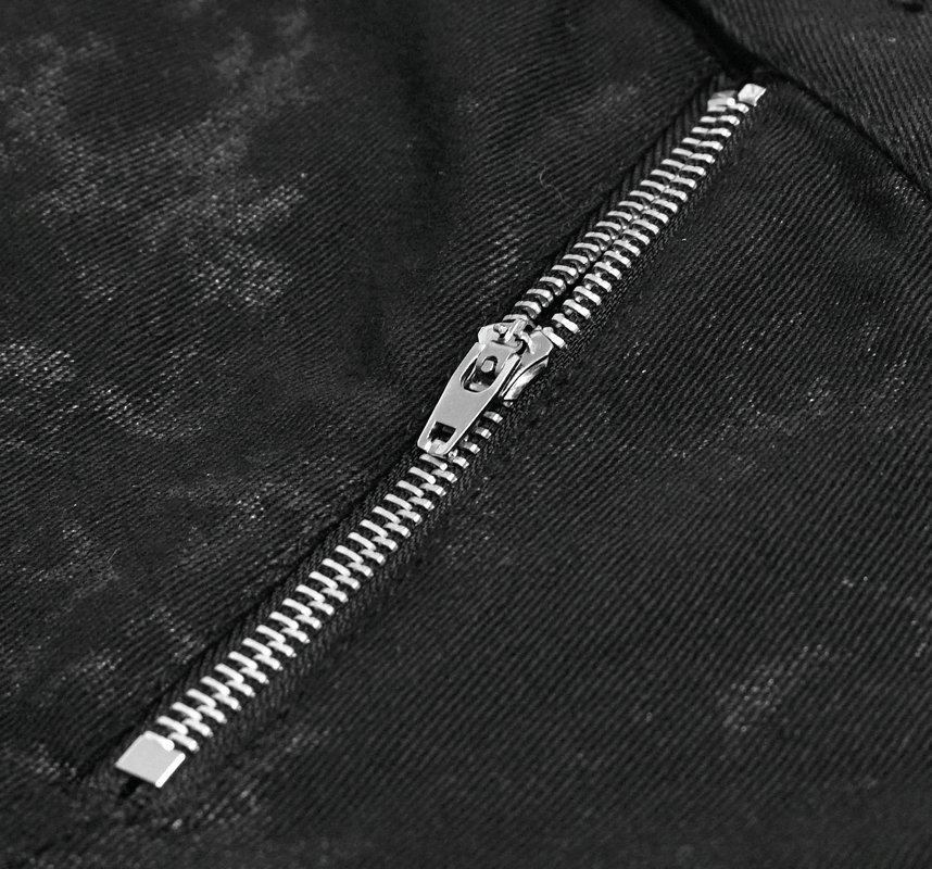 Close-up of a shiny silver zipper on black punk skinny jeans, showcasing edgy style and detail.