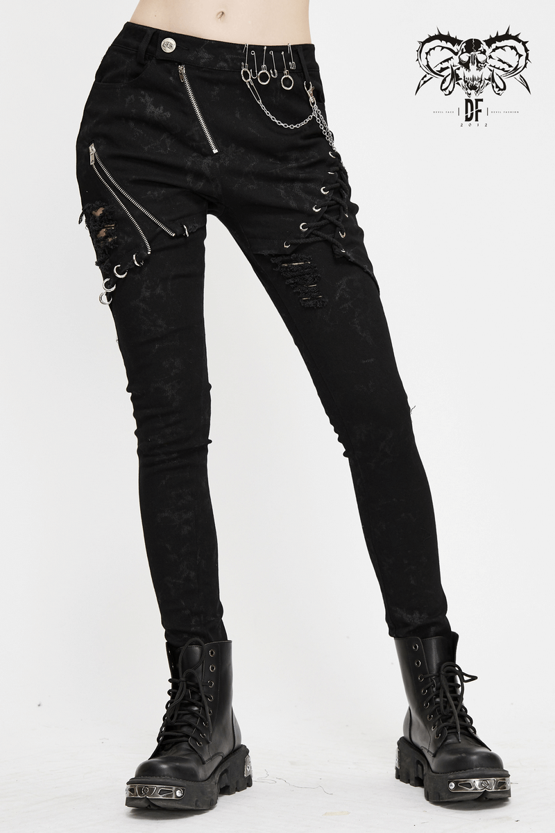 Biker women's punk skinny jeans with lace-ups and silver chains, stylish and edgy black grunge ripped trousers.