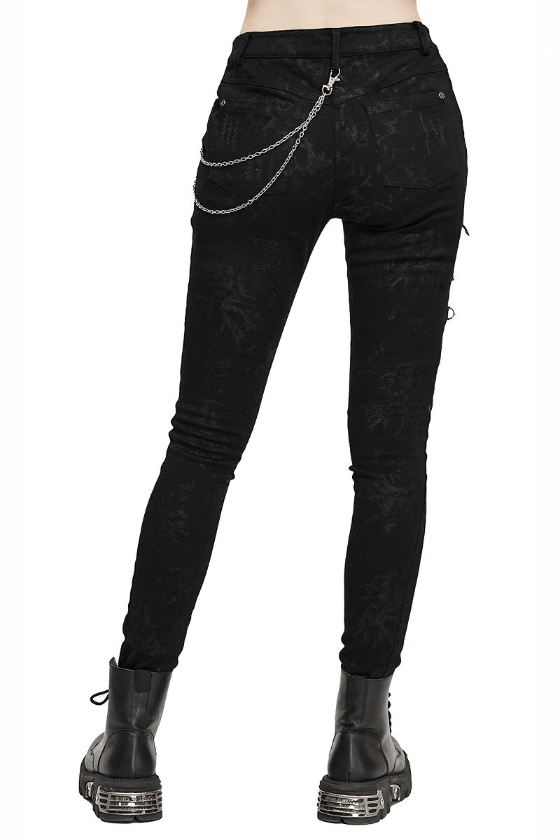 Women's black punk skinny jeans with lace-up detail and chain embellishment, perfect for a grunge look.