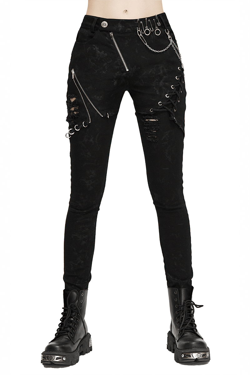 Stylish women's black punk skinny jeans with lace-up details and silver rivets, perfect for a grunge look.