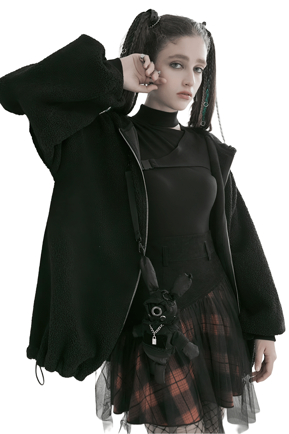 Model showcasing a black and orange plaid mesh skirt with punk rave style, paired with a cozy black jacket.