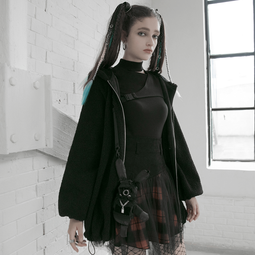 Edgy fashion look featuring a model in a black and orange plaid mesh skirt, oversized jacket, and accessories.