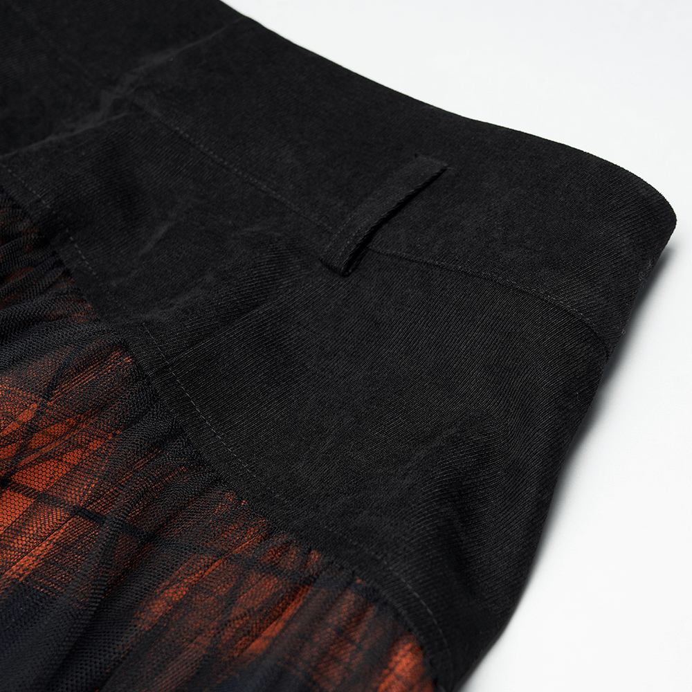 Close-up of the high-waisted black and orange plaid mesh skirt showcasing its unique fabric and stylish hem details.