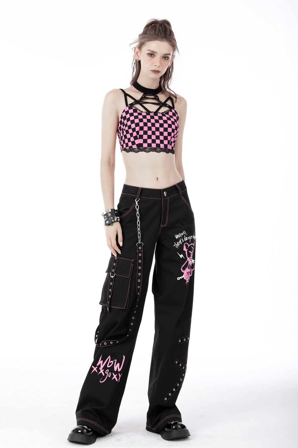 Edgy black and pink checkered halter crop top with strappy design, styled for a punk rock look.