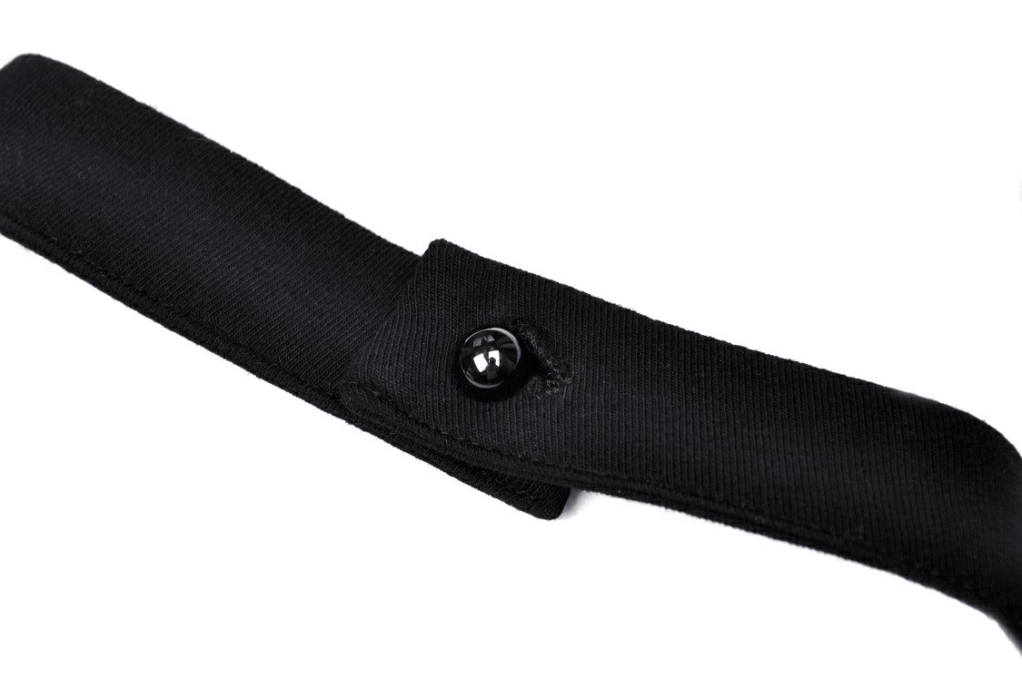Close-up of a black strap with button detail, ideal for punk rock fashion accessories.