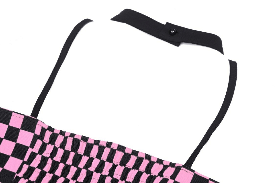 Close-up of black and pink checkered punk rock halter crop top, showcasing the strappy design and fastening.