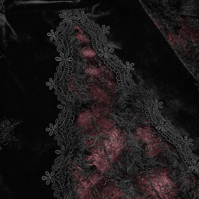 Close-up of black velvet dress with elegant red lace detailing, showcasing a gothic style and intricate floral patterns.