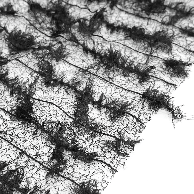 Close-up of black textured fabric with frayed edges, perfect for Gothic-themed clothing or accessories.