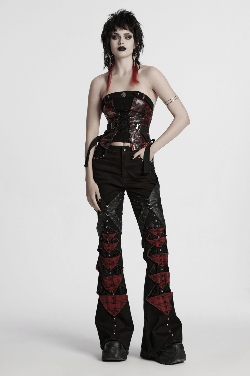 Black and red plaid gothic flared pants with spikes, paired with a stylish corset, showcasing punk fashion vibes.