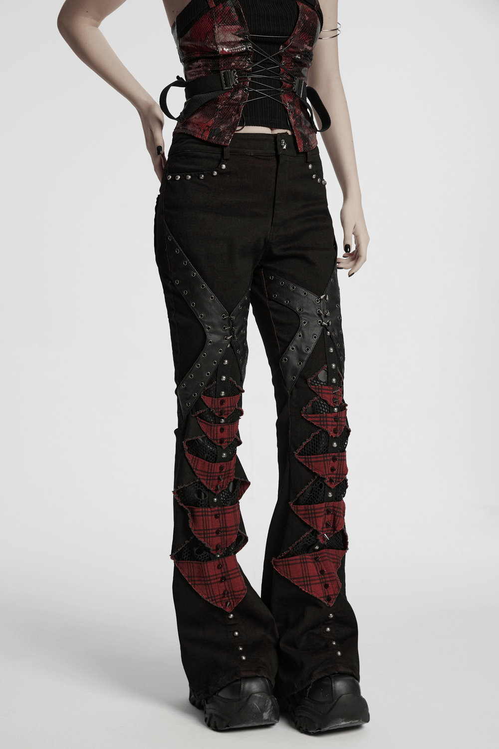 Black and red plaid gothic flared pants with studs and spikes, showcasing a punk style with edgy details.