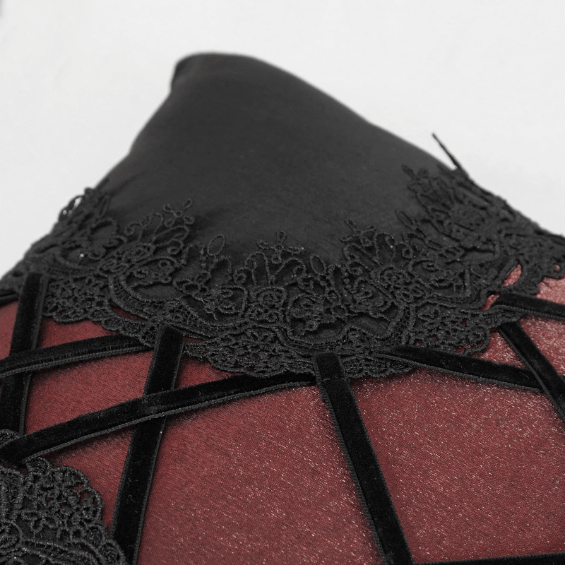 Close-up of black and red satin pillow with intricate decorative lacing for gothic-style decor.