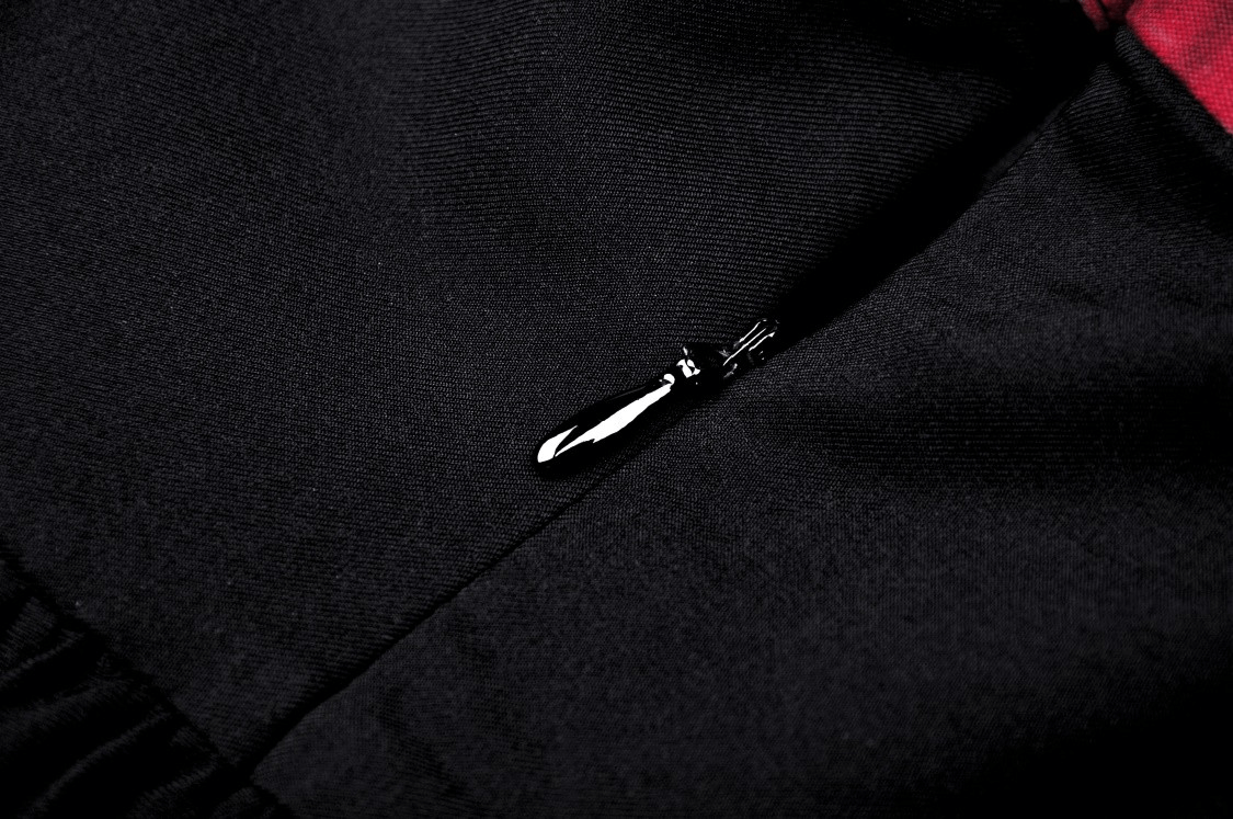 Close-up of the zipper detail on the black and red gothic dress, showcasing its stylish design and quality craftsmanship.