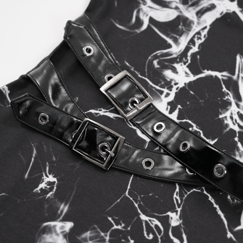 Close-up of black faux leather buckles on a gothic asymmetrical dress with smoky marble print.