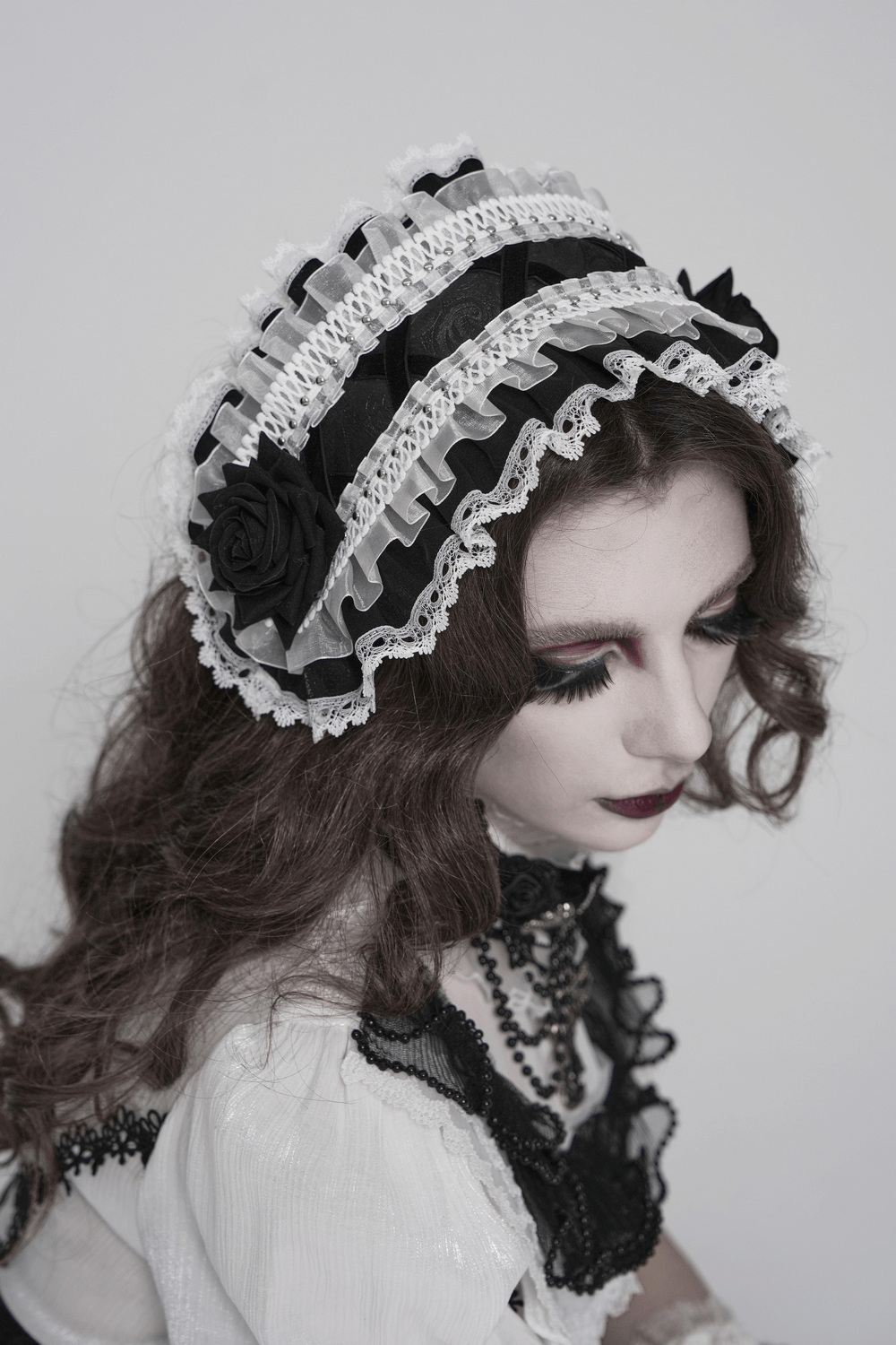 Black and White Gothic Lolita Lace Bonnet with Roses worn by a model, showcasing layered lace and elegant ruffles.