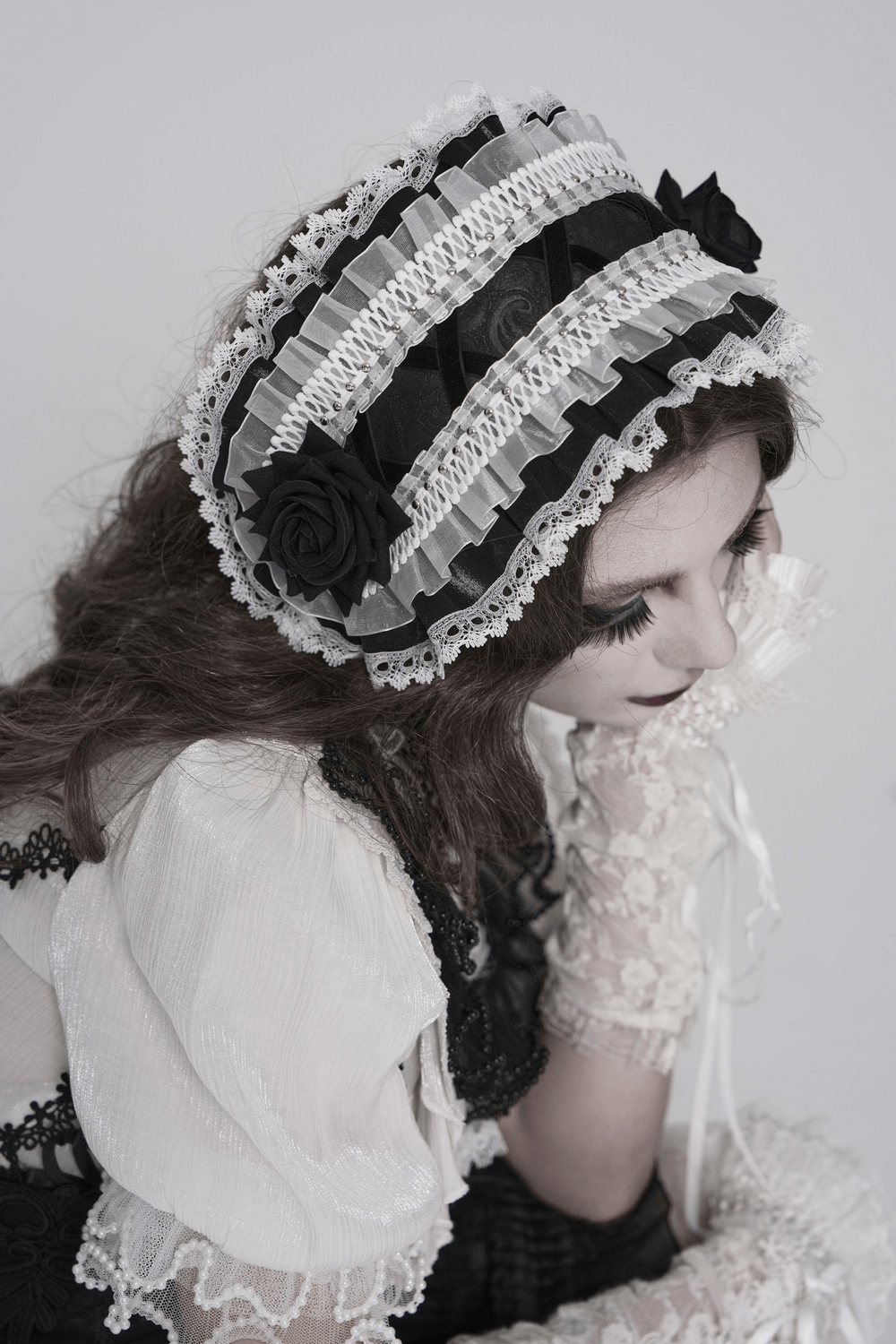 Black and White Gothic Lolita Lace Bonnet with Roses worn elegantly, showcasing layered lace and black rose accents.
