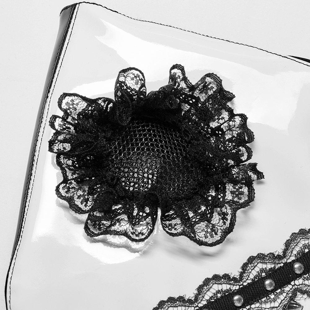 Black lace flower detail on a glossy patent leather surface, adding gothic elegance to a stylish accessory.