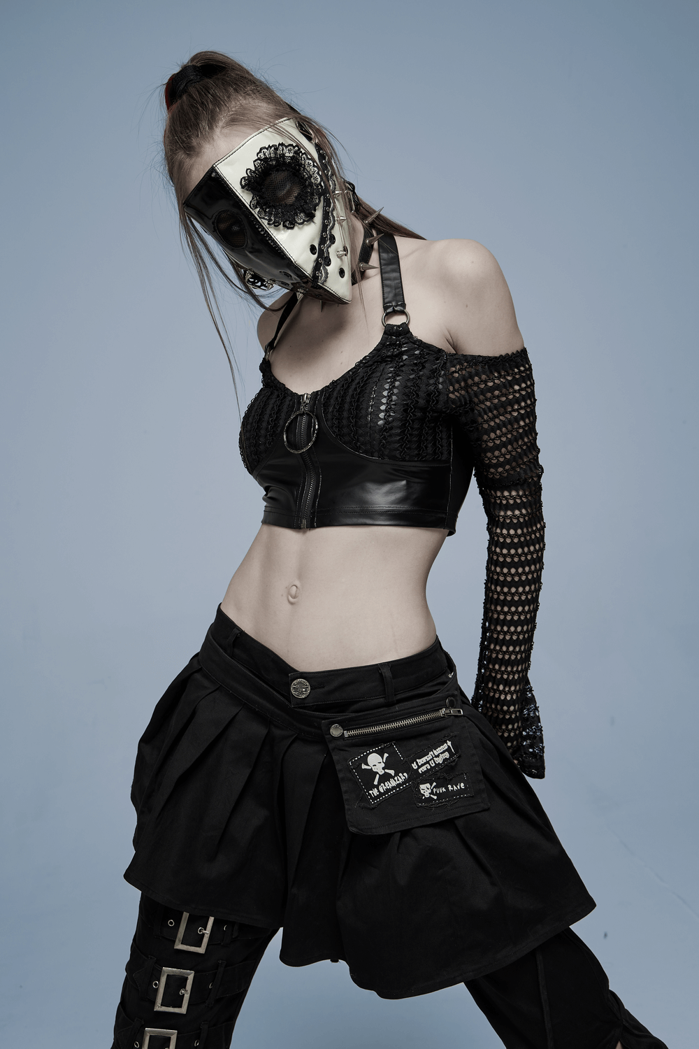 Black and white gothic mask with lace, worn by model in edgy dark fashion, showcasing alternative style and aesthetic.