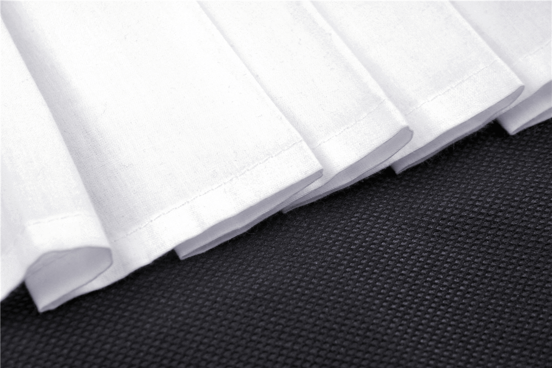 Close-up of pleated white fabric overlay on sleek black base, highlighting the punk mini skirt's edgy design.