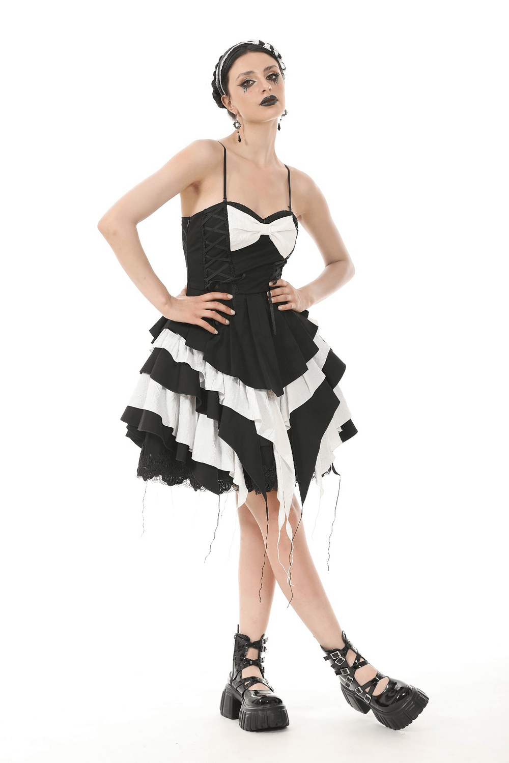 Black and white ruffled Gothic dress with lace detailing and adjustable straps, styled for alternative fashion.