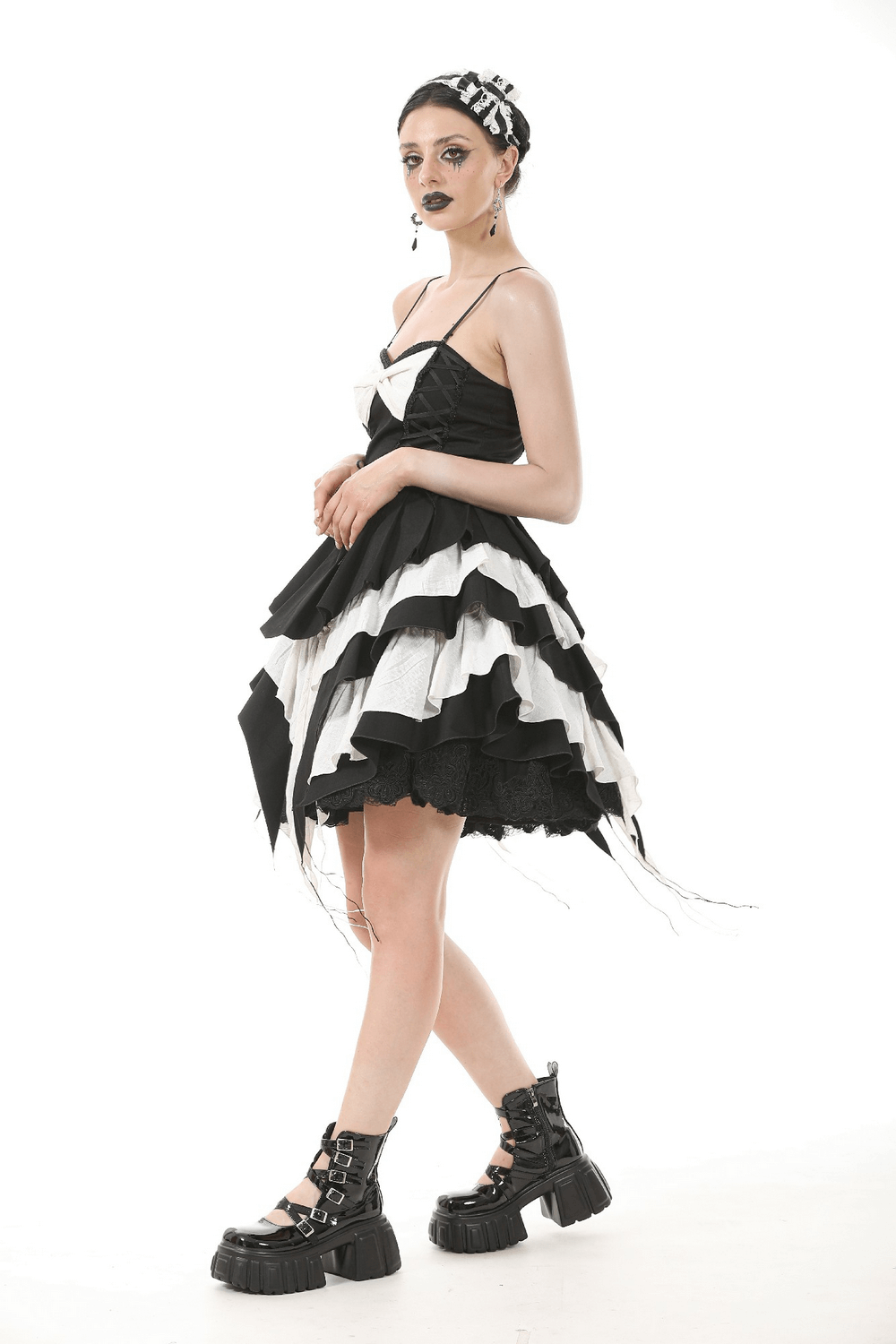 Striking black and white ruffled Gothic dress with lace details and a chic bow, perfect for alternative fashion enthusiasts.