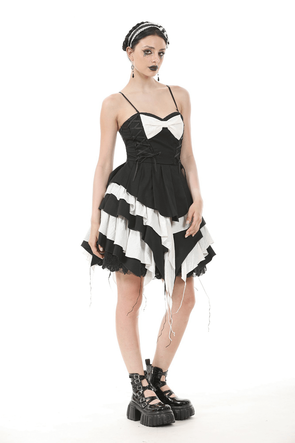 Black and white ruffled gothic dress with lace details, adjustable straps, and statement bow.