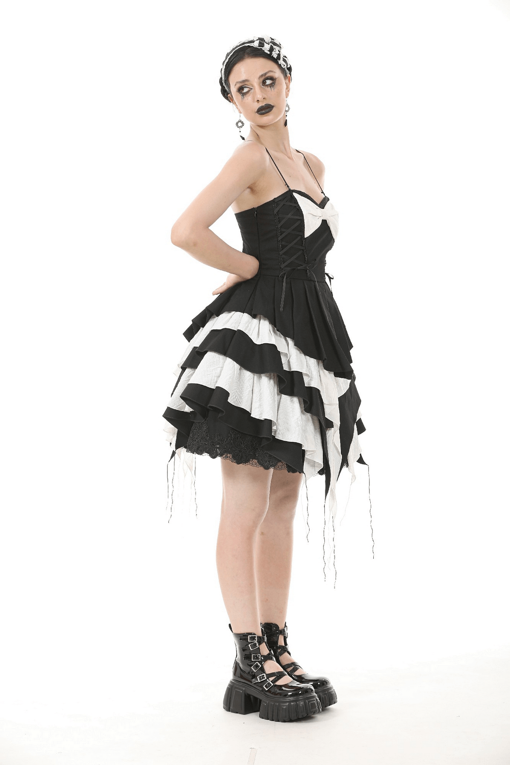Black and white ruffled Gothic dress with lace and bow, featuring layered design and adjustable straps.
