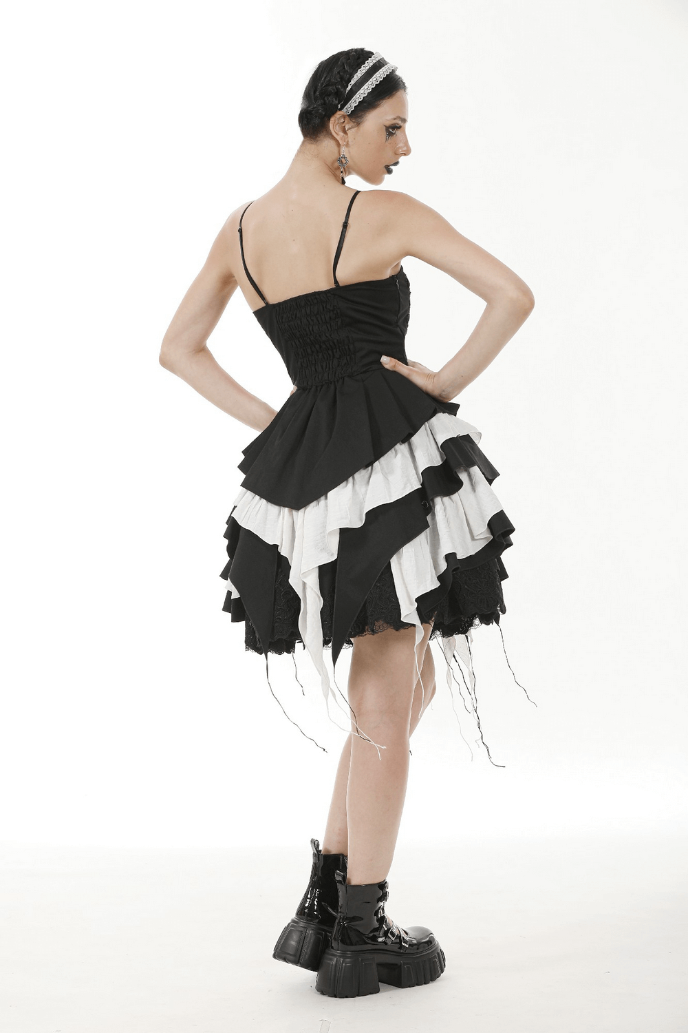 Back view of a black and white ruffled Gothic dress with lace, showcasing the layered design and adjustable straps.