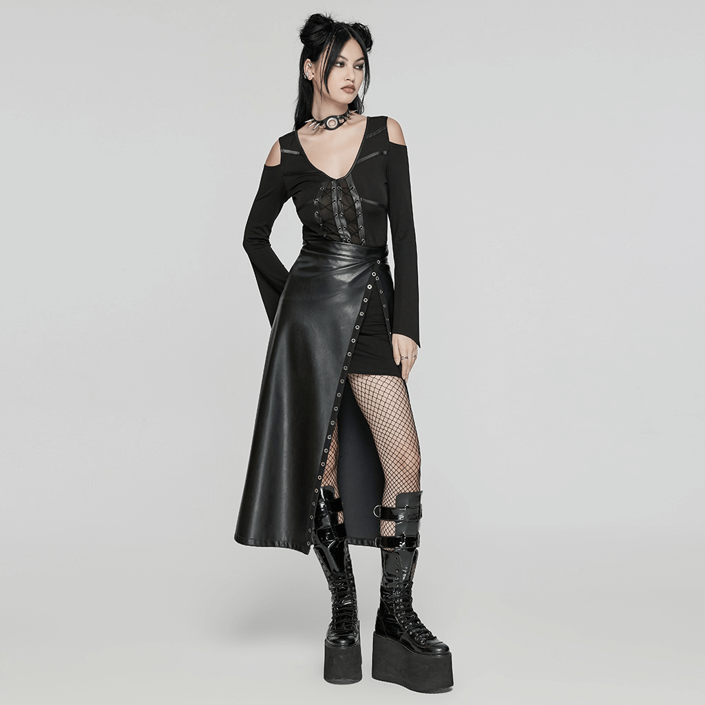 Black artificial leather maxi skirt with eyelet details and diagonal slit, paired with edgy footwear and accessories.