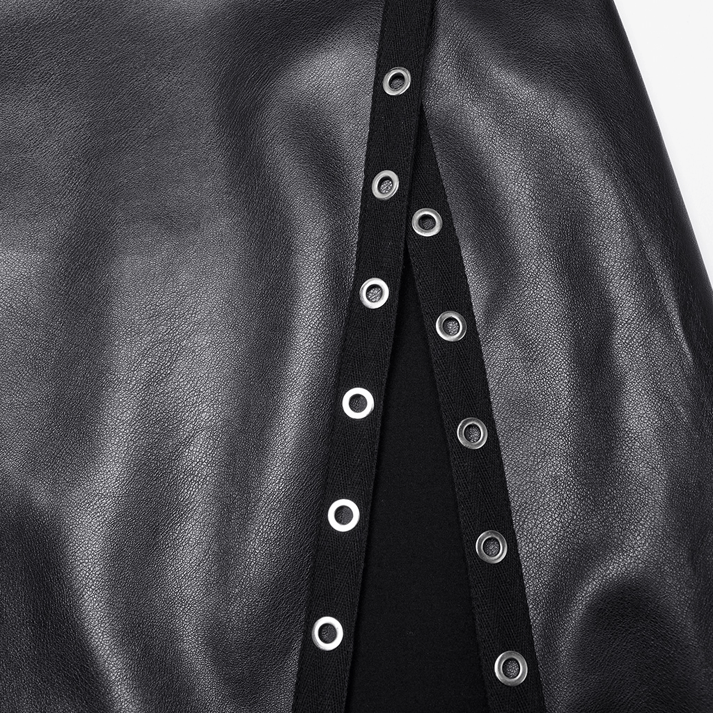 Close-up of black artificial leather maxi skirt with diagonal slit and metal eyelet details.
