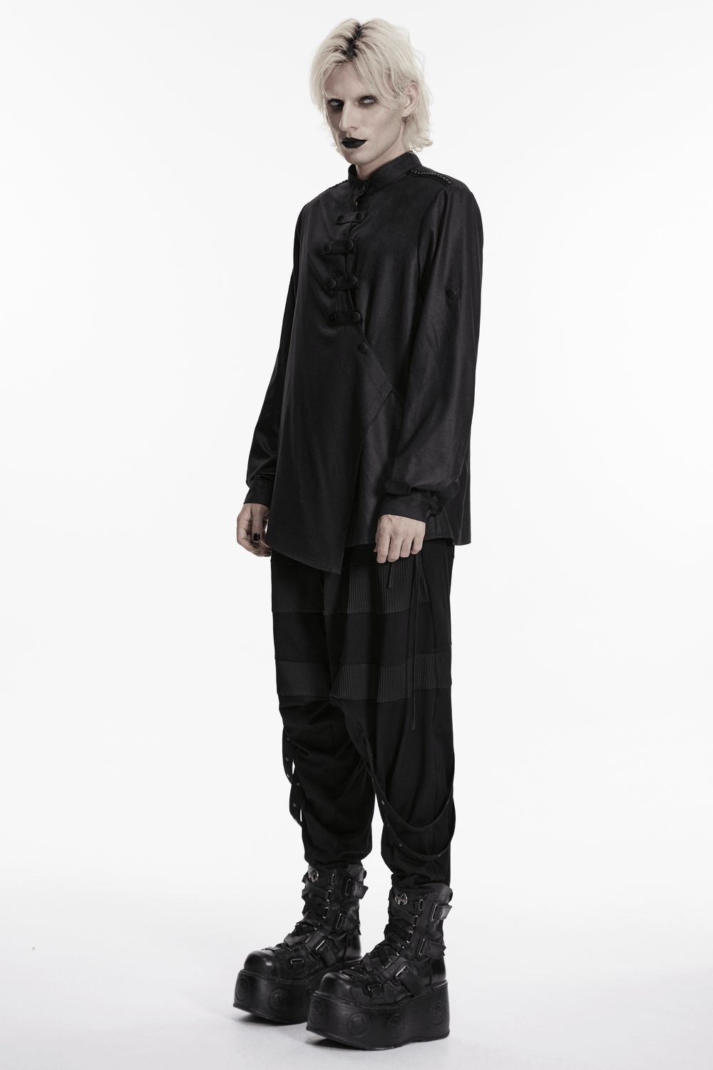 Black Asymmetric Punk Shirt with Hardware Straps styled with dark pants and chunky boots, showcasing a bold alternative fashion look.