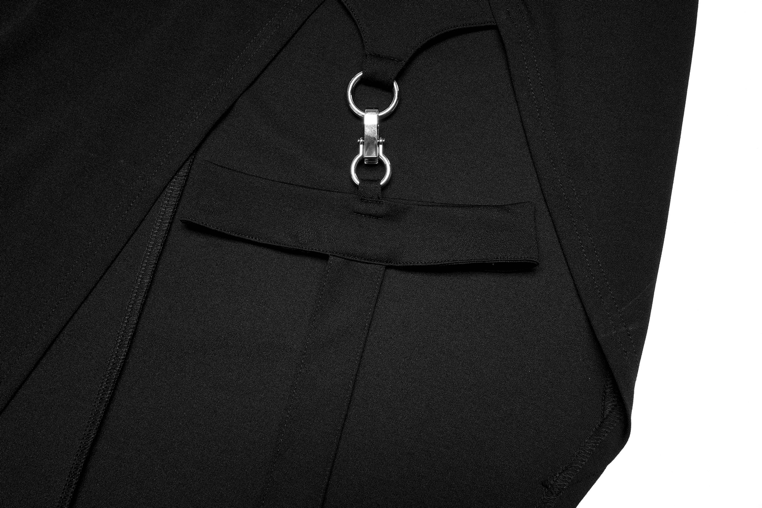 Close-up of the edgy black dress featuring punk cross-leg loops and sleek detailing.