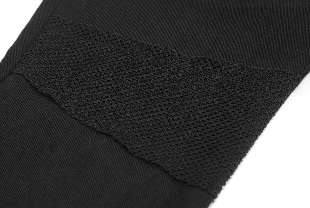 Close-up of black asymmetrical pants showcasing a textured mesh panel, perfect for a gothic trendy look.