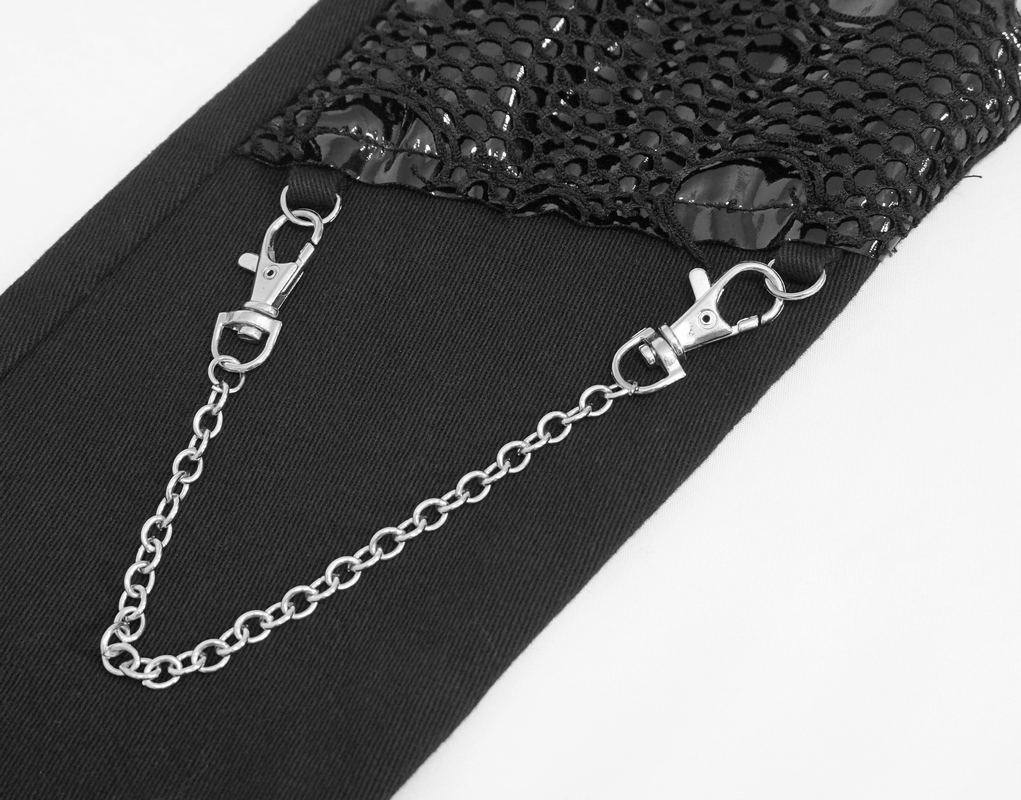 Close-up of black asymmetrical pants with silver chains and mesh detailing for a gothic style look.
