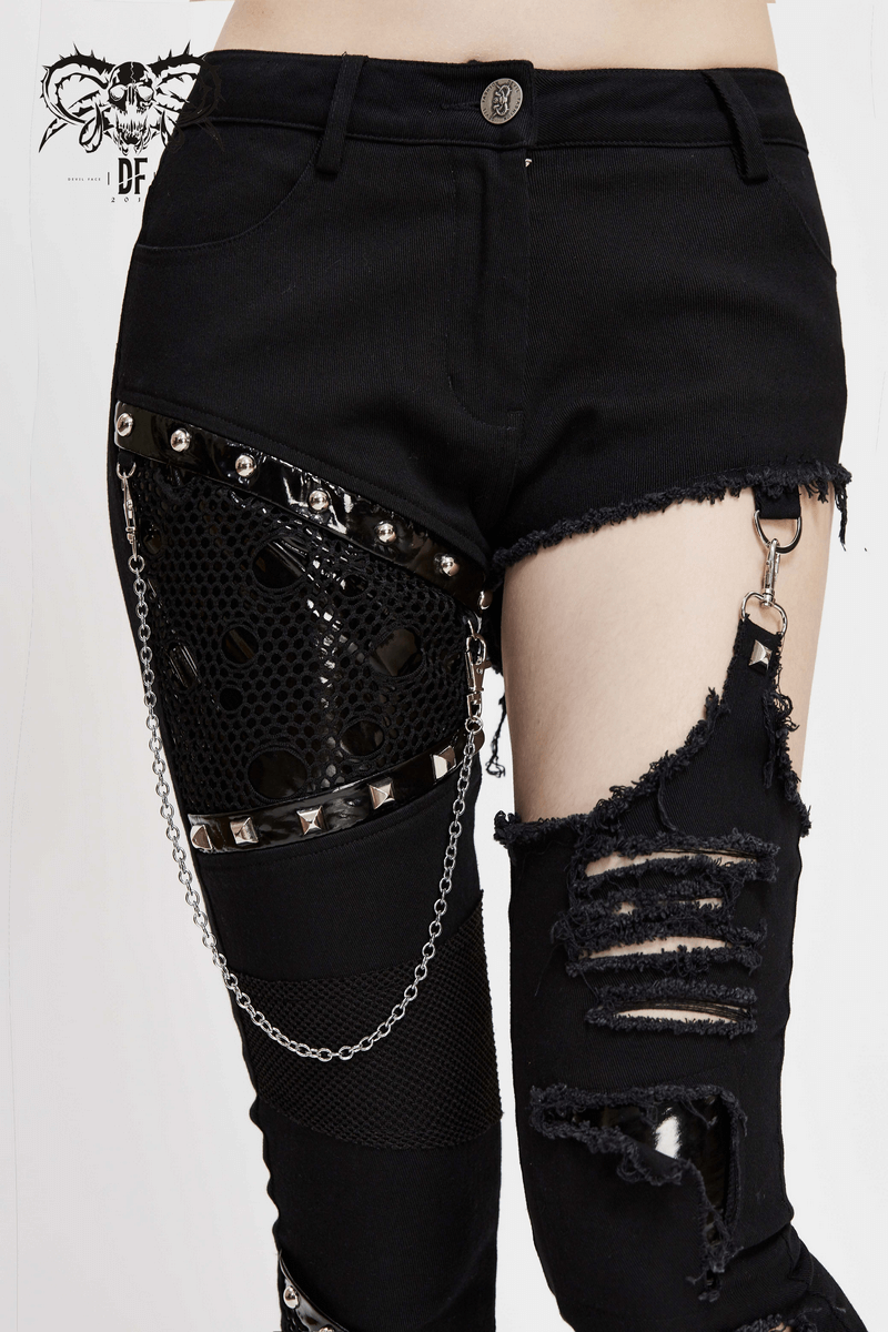 Trendy women's black asymmetrical pants with chains and ripped details, showcasing gothic style and edgy fashion.