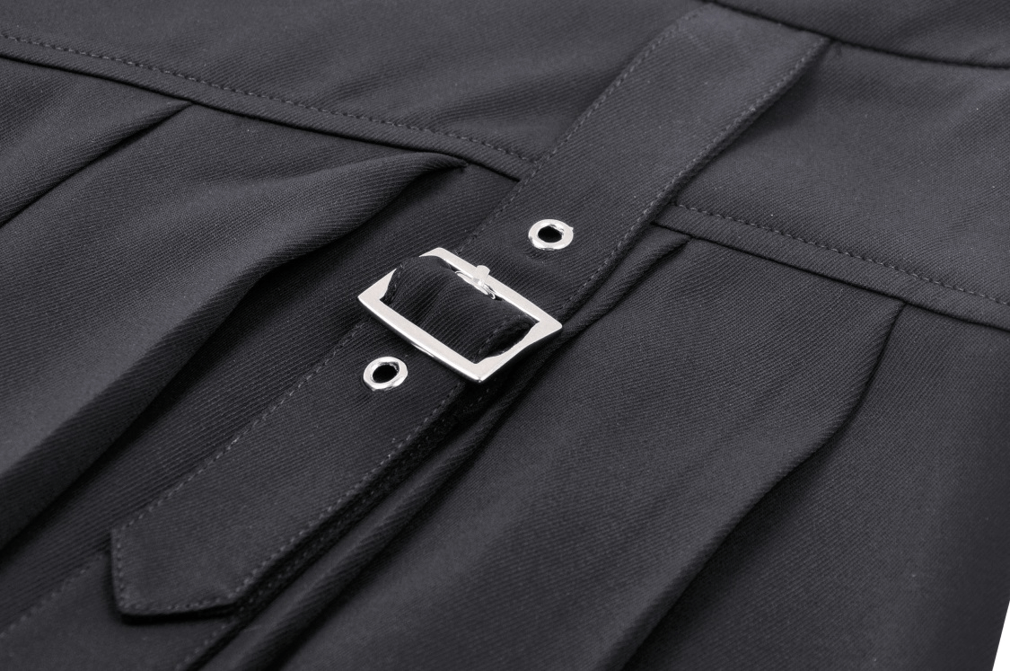 Close-up of black pleated punk skirt buckle detail with safety pin accents, designed for an edgy, gothic look.