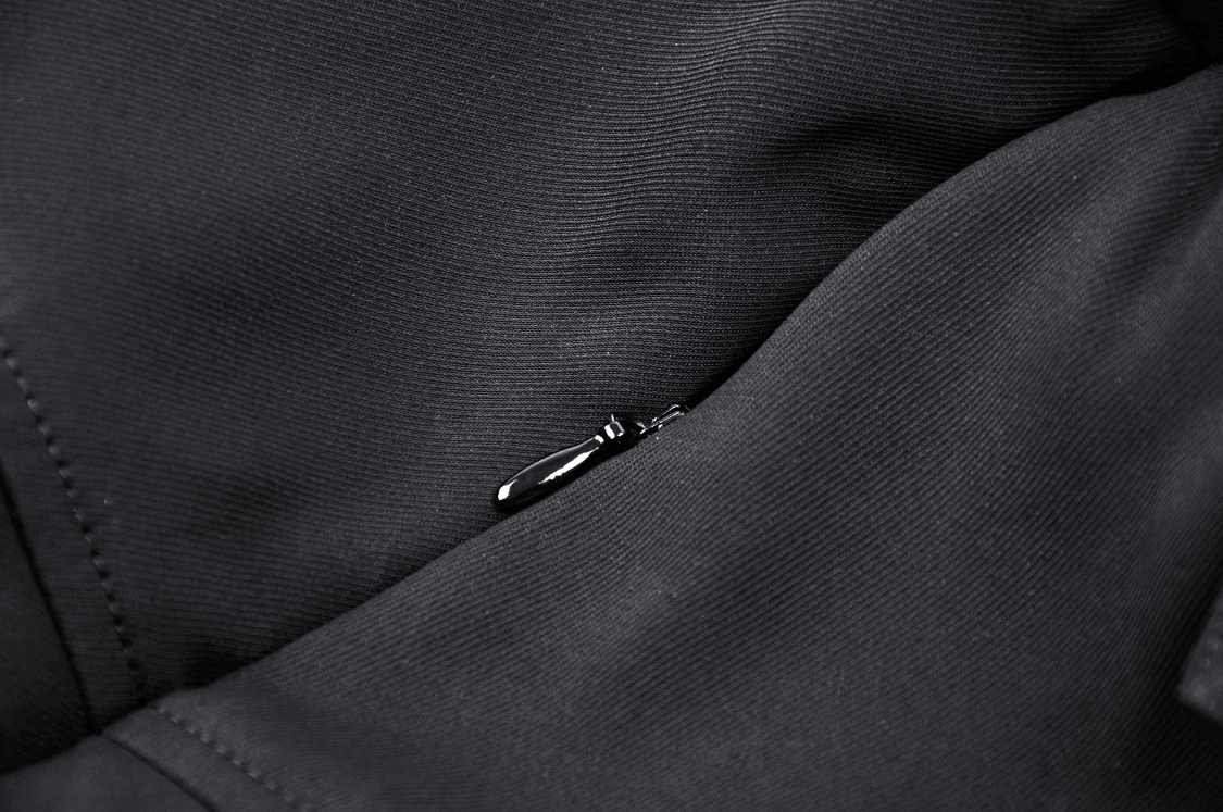 Close-up of a sleek black fabric with a hidden zipper detail, showcasing modern design and functionality.