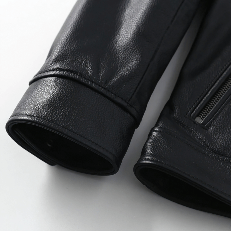 Close-up of black biker leather jacket sleeves showcasing premium leather texture and stylish zip details.