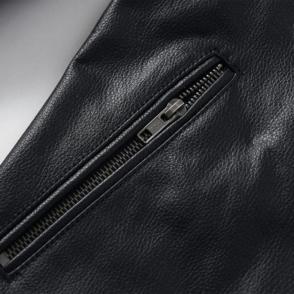Close-up of the zipper detail on a black biker genuine leather jacket for men.