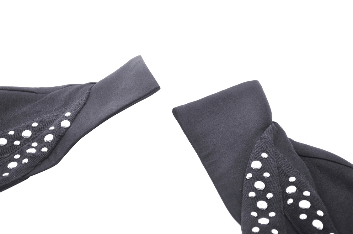 Close-up of long sleeves of a black bolero jacket adorned with sparkly bead embellishments.