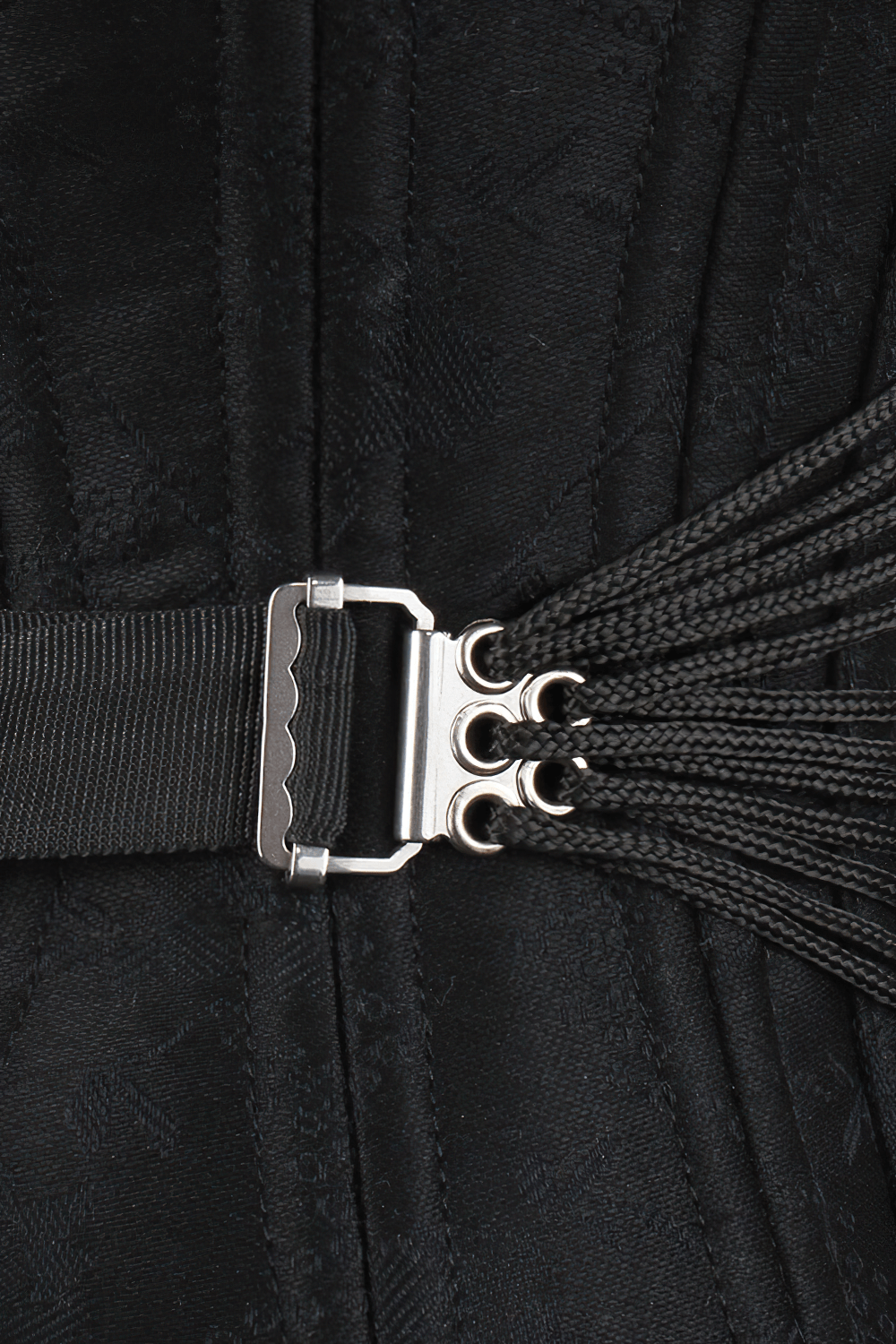 Close-up of black brocade corset's adjustable fan lacing, showcasing precision and elegance for waist training.