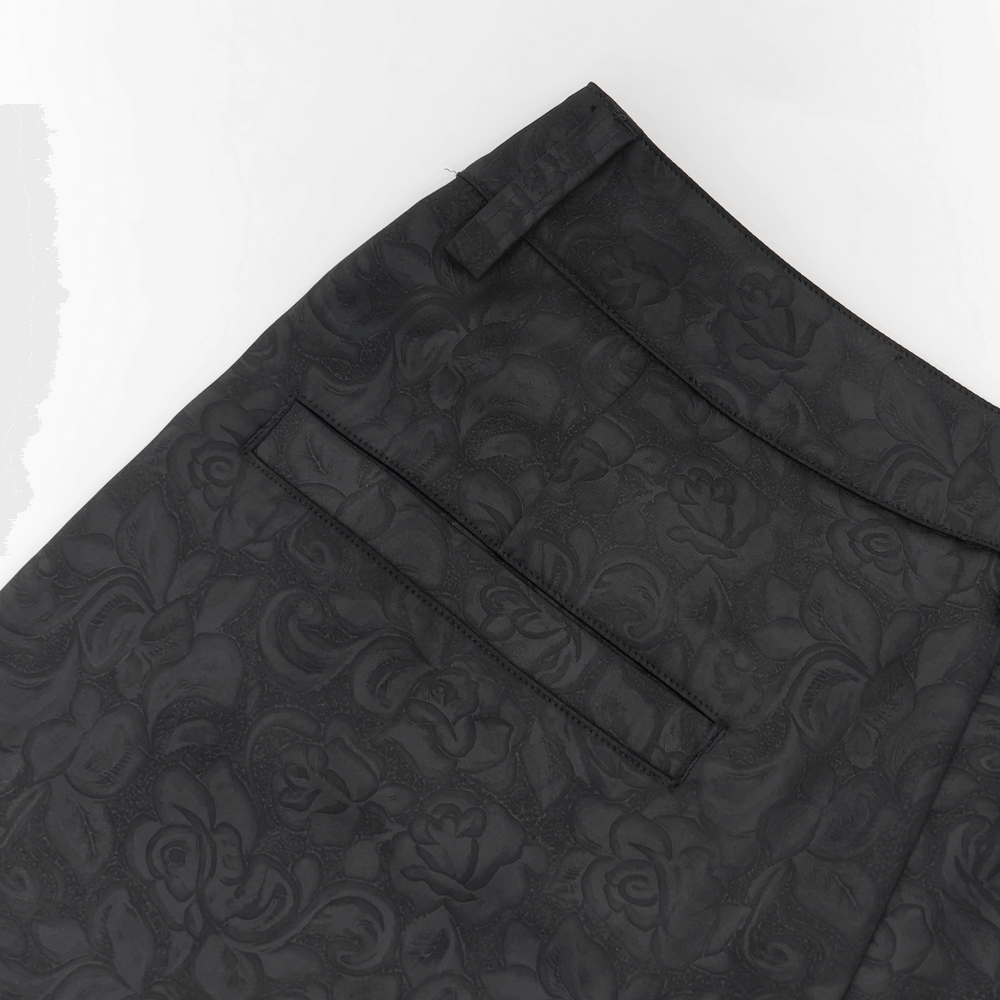 Close-up of black brocade gothic pants showcasing intricate embroidered floral details.