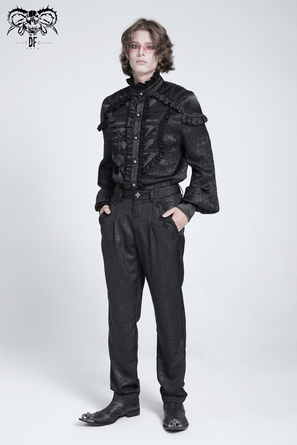 Stylish model wearing black brocade gothic pants with embroidered details, exuding an edgy and elegant look.