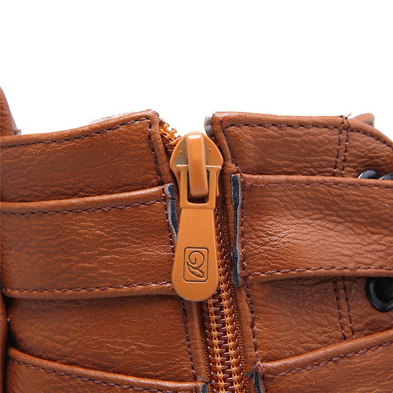 Close-up of zipper detail on brown lace-up buckle ankle boot, showcasing its stylish design and functional ease.