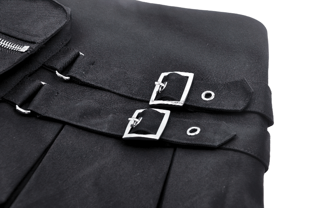 Close-up of black mini skirt with buckle accents and side zipper for an edgy, stylish look.