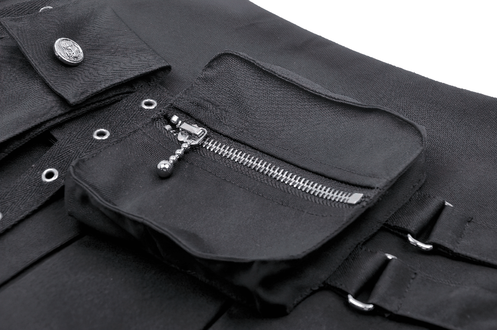 Close-up of the side zipper pocket on a black pleated mini skirt with buckle accents.