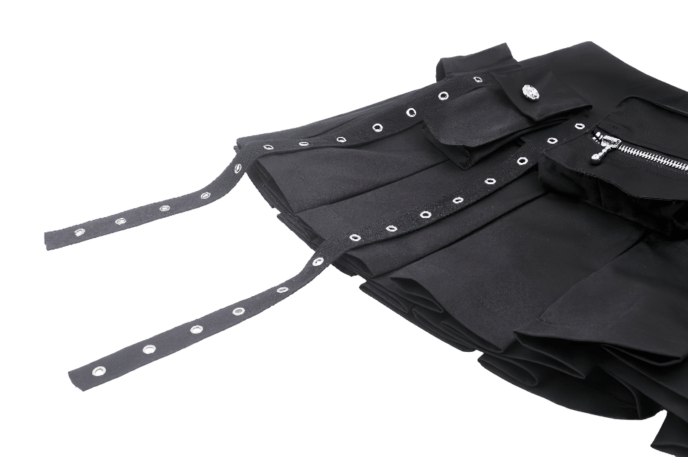 Close-up of a black pleated mini skirt showcasing buckle details and a side zipper.