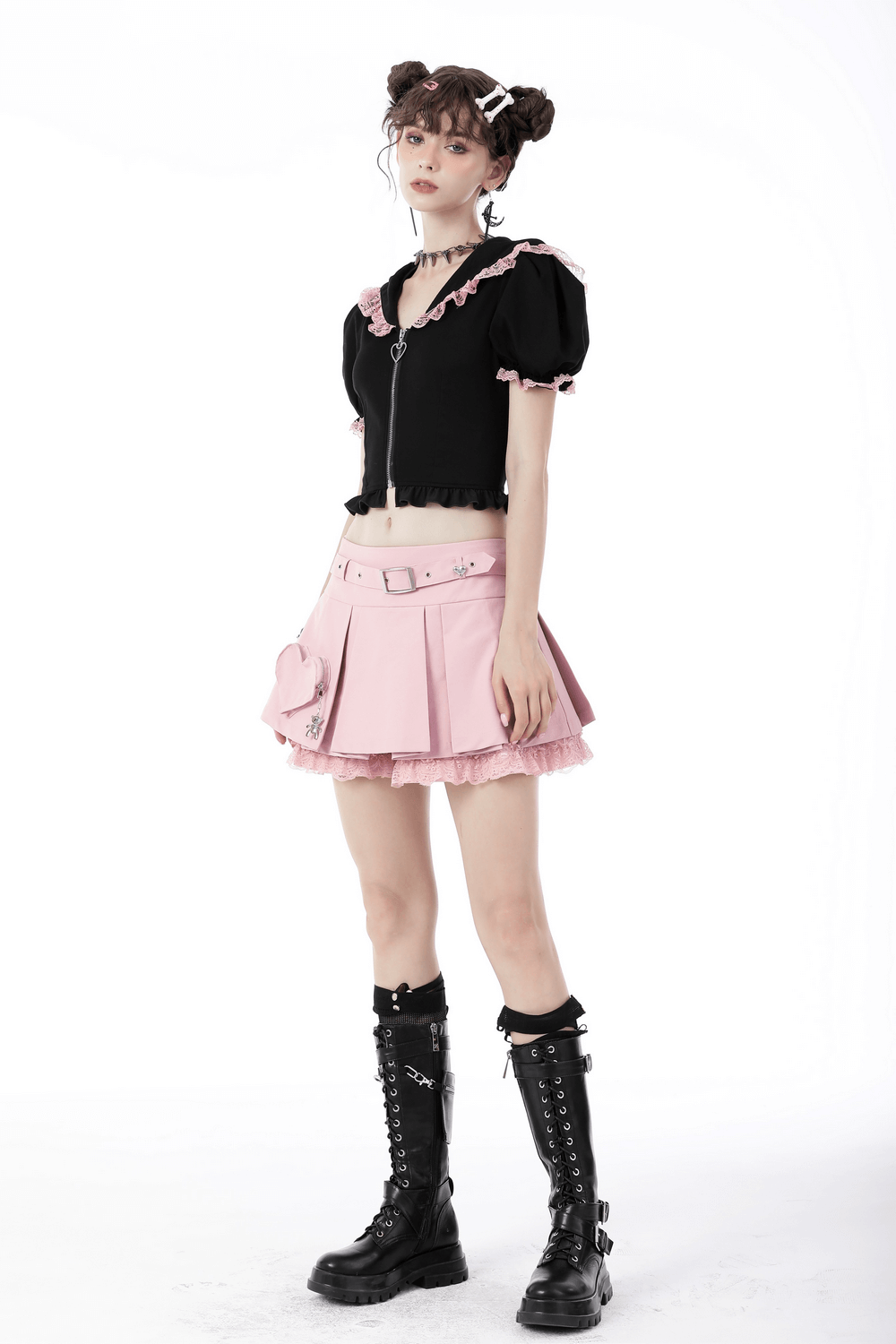 Model wearing a black cat ear crop top with a pink lace collar and a pink skirt, paired with stylish combat boots.